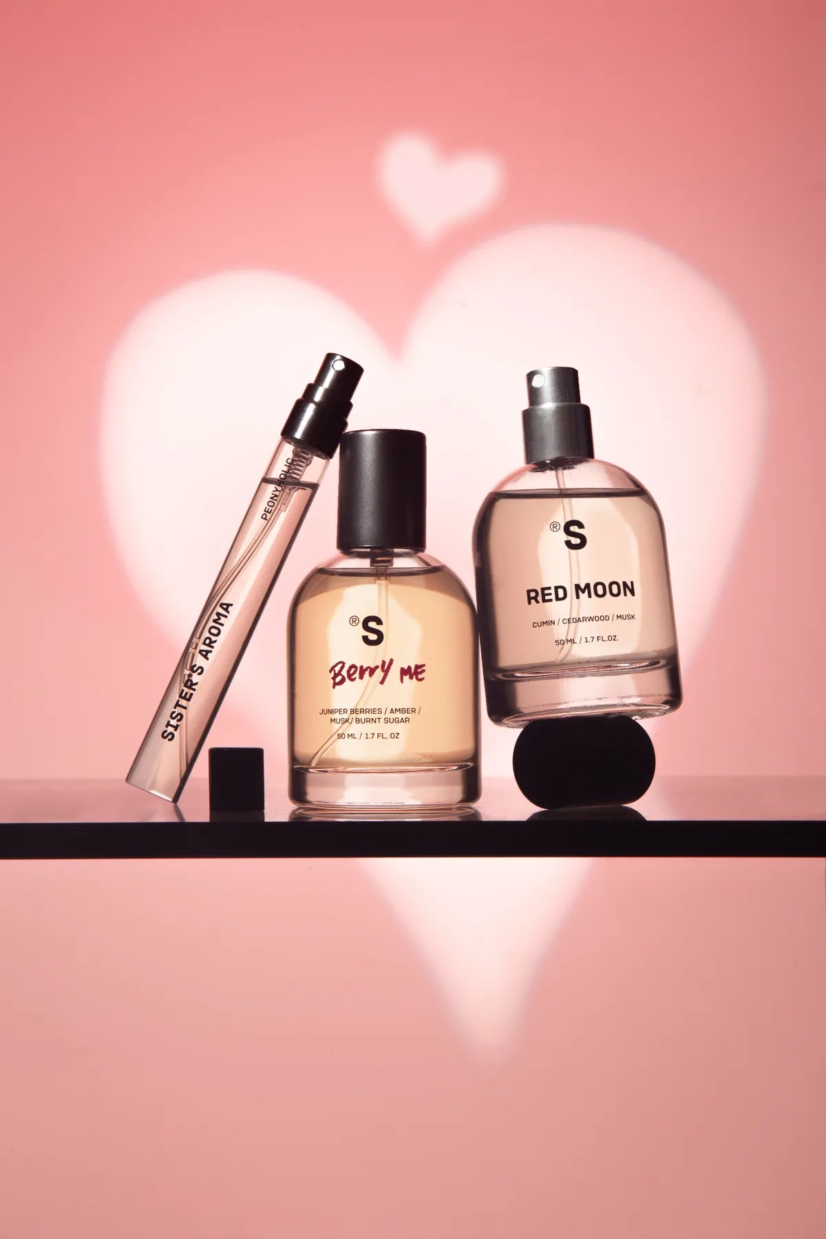Sister’s Aroma perfumes in pink heart-shaped light
